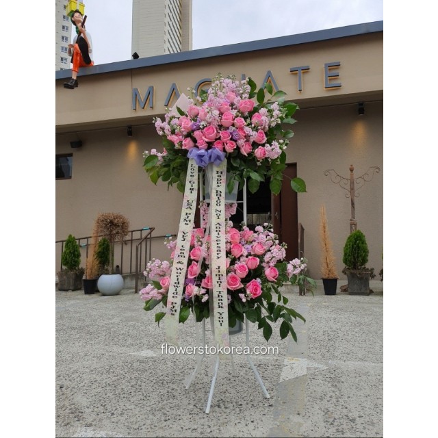 2-tier Gland opening congratulations Standing Spray Roses & seasonal flowers